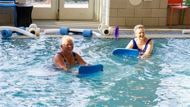 Two women enjoying an aquafit class at the midco aquatic center