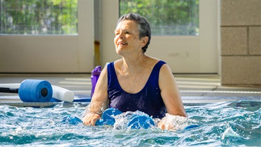 Woman smiling and enjoying her aquafit class