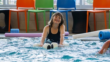 Aquafit teacher smiling and enjoying her aquafit class