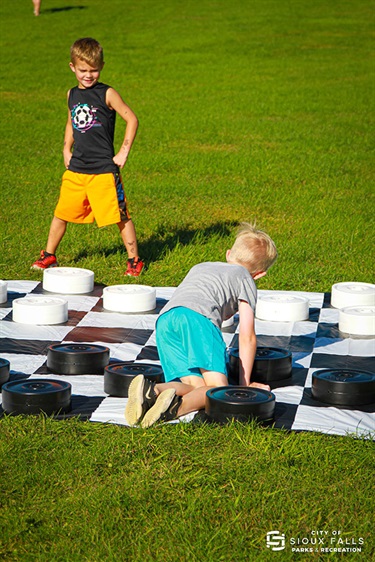 Kids playing giant checkers