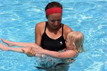 Swim instructor with child