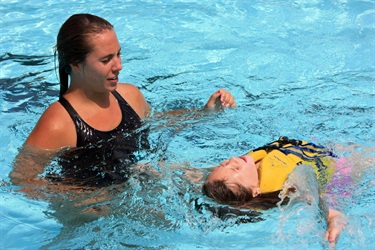 Student floating in pool