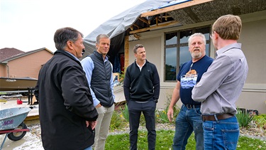 Public officials touring tornado damage to a Sioux Falls home