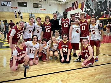 Mayor posing with youth basketball players