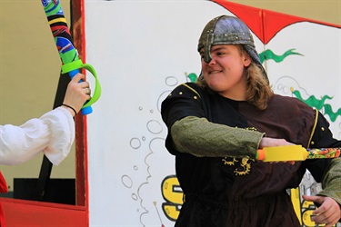 actors in costume performing on stage