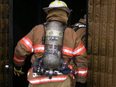 Firefighter going into a building