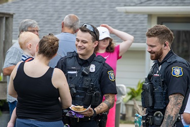 Police officer laughing with citizens