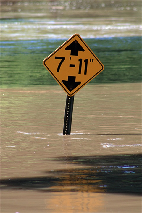 Flooding in Rotary park with water almost covering an entire sign