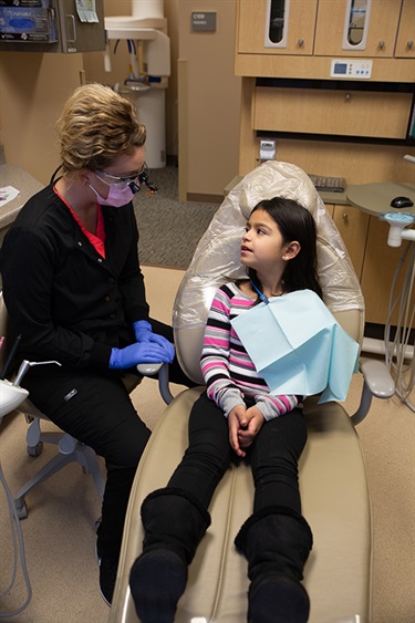 Dental hygenist working on a child