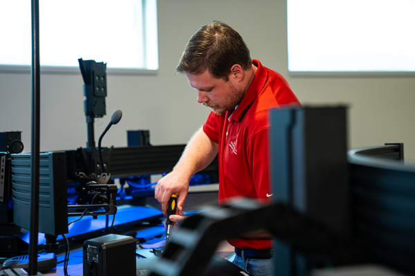 Innovation Technology employee installing monitors at the new public safety campus