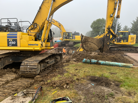 Installing the watermain across Cherry Lake Avenue after the pavement was removed.