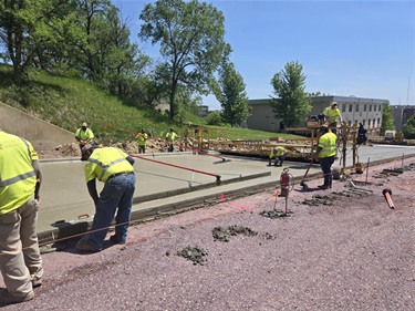 Workers screening new concrete