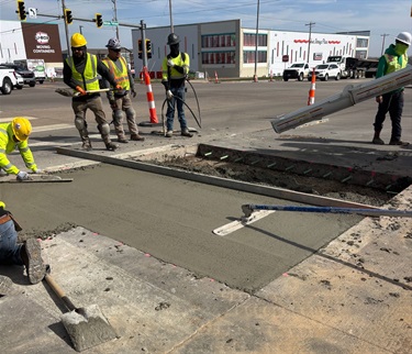An image of workers smoothing newly poured concrete