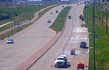 A view of workers cutting concrete in a a traffic lane