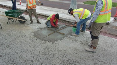 Crews performing partial-dpeth concrete repairs