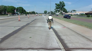 Crews applying a soy based sealant to the new concrete