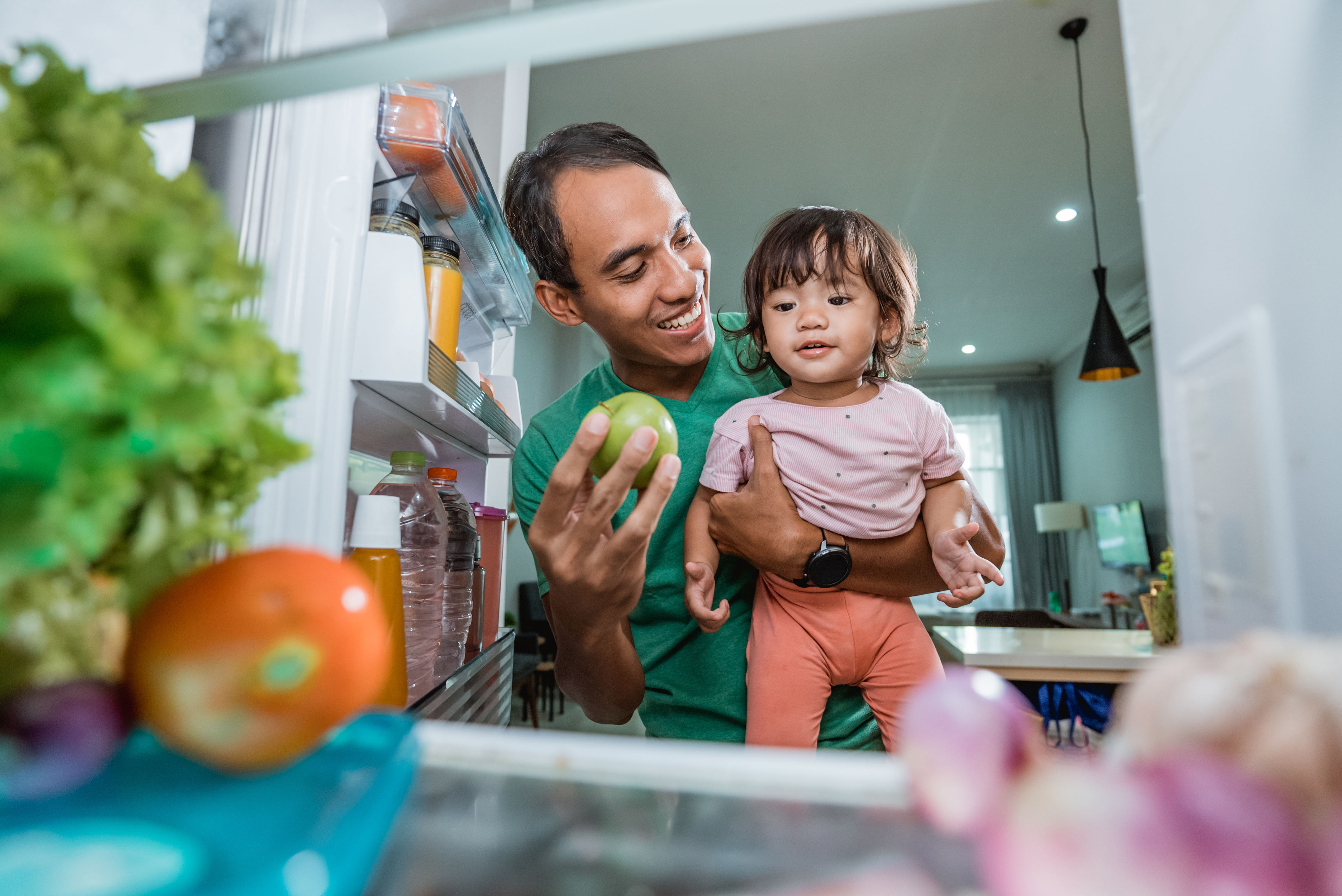 A father and daughter looking a the fridge