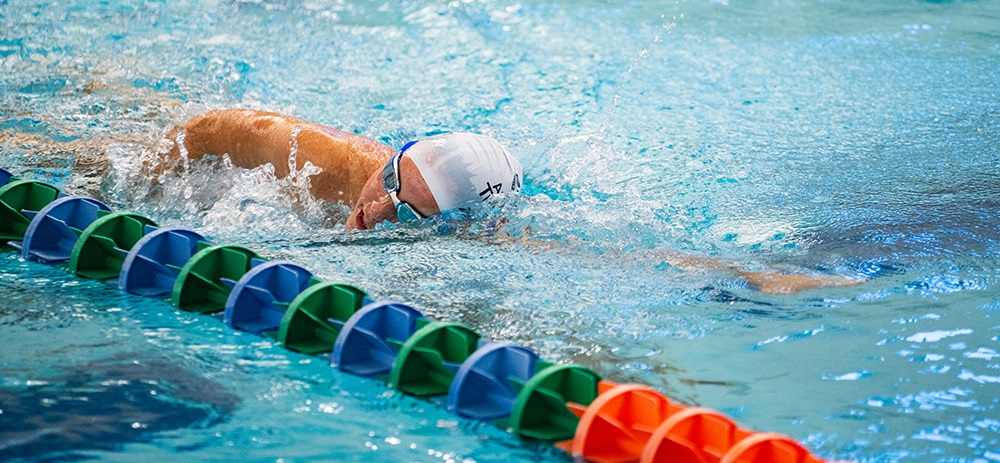 Man swimming laps at the midco aquatic center