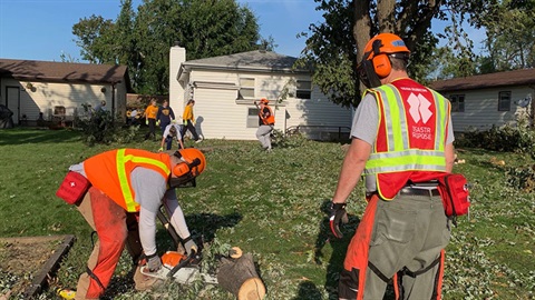Storm clean up volunteers picking up branches