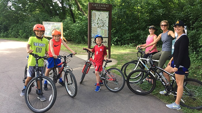 Women and children riding bikes together