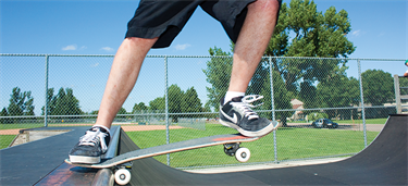 Skateboarder about to use the skate ramp