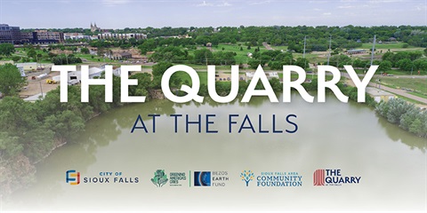 The words The Quarry at the Falls superimposed on an aerial photo showing the quarry with partner logos.